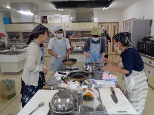先生から説明を受けて調理に取り組んでいる